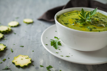 Fresh vegan plate of zucchini cream soup
