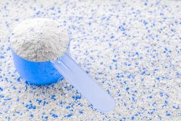 Washing detergents. White wash soap texture with cup for laundry background. Liquid powder in scoop for machine. Housekeeping and household, domestic housework cleaning service concept.