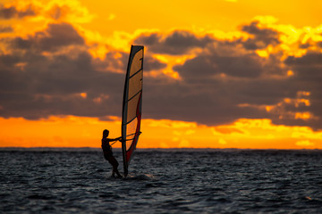 girl riding windsurf on the background of an incredible sunset. Mauritius Island