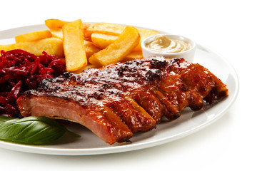 Barbecue pork ribs and vegetables on white background
