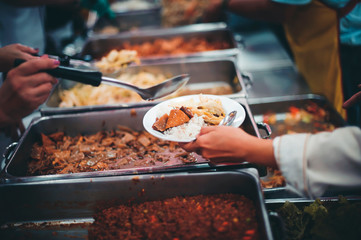 The concept of poverty leads to food shortages: homeless people wait to receive food donations from donors