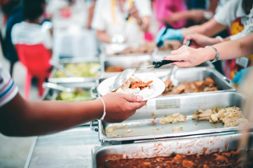The concept of poverty leads to food shortages: homeless people wait to receive food donations from donors
