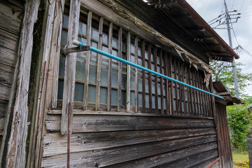 Fototapeta premium The windows of a decaying wooden building where no one lives