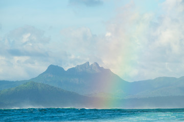 A huge rainbow against the backdrop of picturesque mountains, waves and ocean. Mauritius Island,...