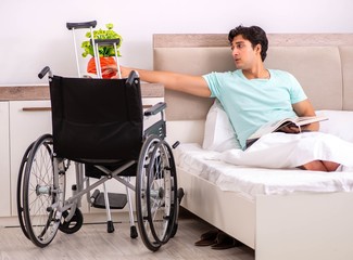 Young handsome disabled man recovering at home