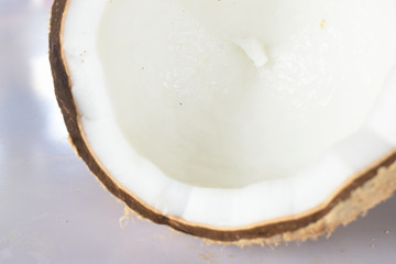 Close up of half of cracked coconut fruit isolated on white background