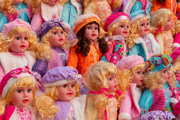 Colourful tiny girl baby dolls for sale at retail shop at Christmas market, New Market area, Kolkata, West Bengal, India.