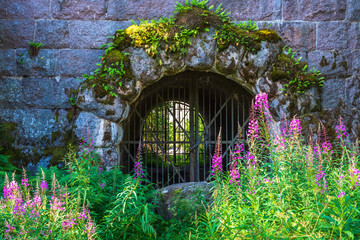 Entrance to Vaberget fortress in Sweden and with flowering fireweed