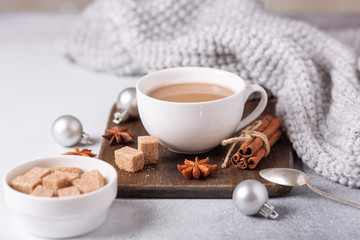 Obraz na płótnie Canvas White cup with coffee and marshmallow, sweater, cinnamon. Cozy christmas composition. Hygge concept Soft focus
