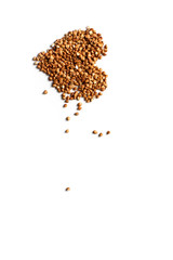 Buckwheat in the shape of a heart on a white background.
