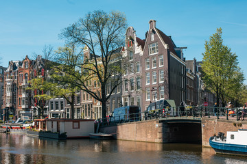 April 2020 - Amsterdam, The Netherlands - Romantic view of Amsterdam city centre canals and boats on Spring time 