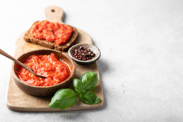 Balkan traditional dish ajvar on a wooden cutting board, place for text