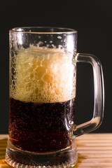 Glass beer on wood background with copyspace
