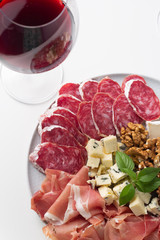 red wine and cheese and meat snacks close-up
