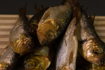 background of golden smoke-dried fish close up