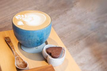 Hot Cappuccino In Cup On Wooden Table With Copy-space. The Latte Art On coffee background.