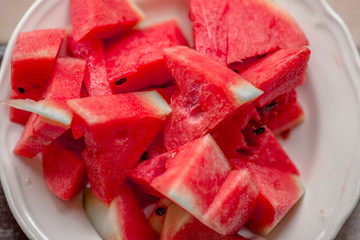 The background of the red flesh watermelon, placed in a ready-to-eat white plate, is a fruit that has a sweet taste and is an alternative health menu.