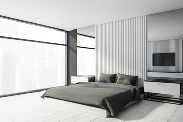 White and gray master bedroom with TV