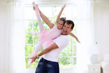 Father and little girl play at home. Dad and child