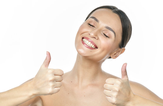 Close Up Portrait Of A Girl With Big Eyes And Clear Skin On A White Background With A Beautiful Wide Smile And White Teeth