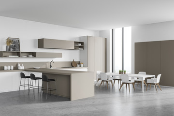 White and beige kitchen corner with bar and table