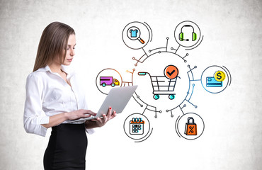 Woman with laptop, online shopping cart