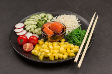 Poke traditional Hawaiian raw red fish salad, bamboo chopsticks. Organic healthy nutrition.