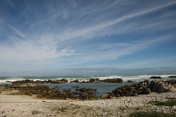 Fototapeta na wymiar rocky beach and cloudy sky south africa