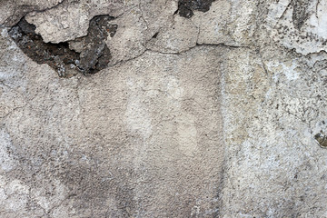 Texture of an old wall with cracks in the plaster. Material, surface, background for the design.