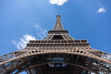 Fototapeta na wymiar Eiffel Tower in Paris on Blue Sky Background. France. Bottom View.