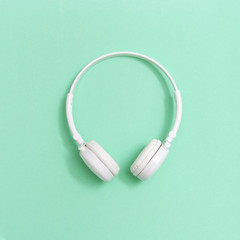 White headphones on paper background. Concept for music festivals, radio stations, music lovers....