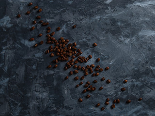 Coffee crumbled on a dark concrete background. Copy space.