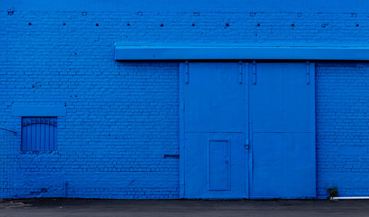 Obraz na płótnie Canvas industrial Blue Brick Wall with large doors