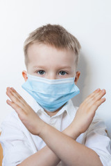 Cute boy in a medical mask. Quarantined children due to an epidemic.