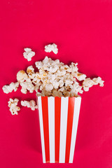 
Popcorn in cardboard box on red background
Conceptual cinema, watch a movie