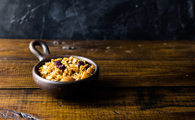 Granola in a clay pots with a beautiful wooden rustic background. Healthy concept. Vegan Concept. Copy space. Top view