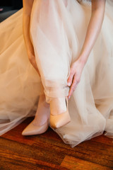 bride straightens her shoes