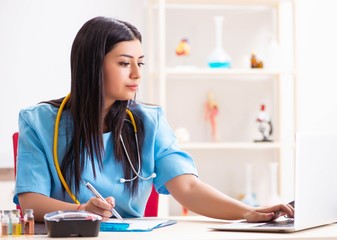 Young beautiful female doctor working in the clinic