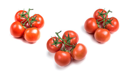 Red tomatoes on a green branch isolated on a white background. Variety of tomatoes. Fresh fruit. Selection of ripe tomatoes.