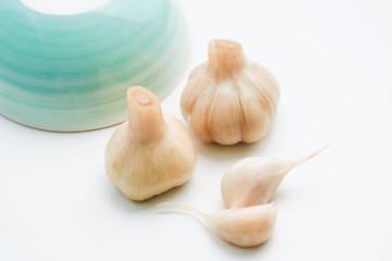 Sugar garlic and blue green ceramic bowl on white background