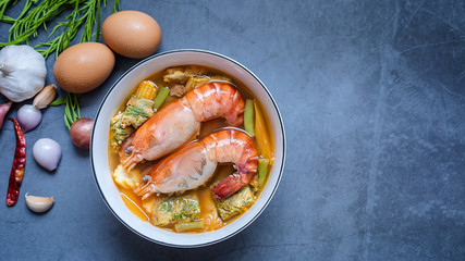Close-up of two shrimps with vegetable sour curry Thai soup with Acacia Pennata omelet and shrimps in a white bowl on the table. The idea of healthy herbal ingredient food and cooking stay home.