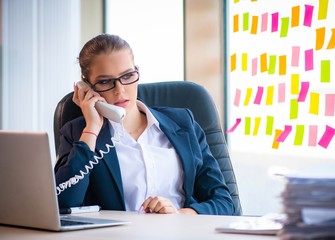 Beautiful female employee with many conflicting priorities