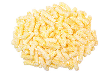 A heap of corn snacks. Sweet sticks of puffcorn top view