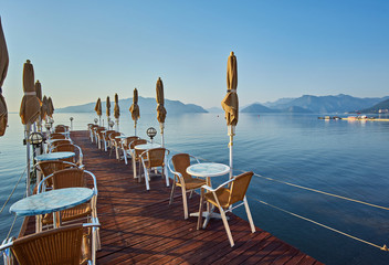 Beach cafe at dawn. Empty tables in a cafe, a sunny morning on the beach.
