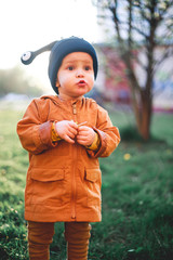 portrait of a one year old boy with a snail wool cap