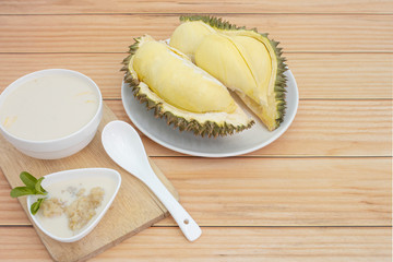 Sticky rice with durian on a wooden background.