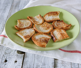 Crispy toast with sugar in a plate on the table