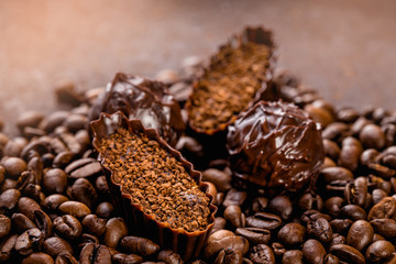 still life of various delicious chocolate pralines on dark textured background