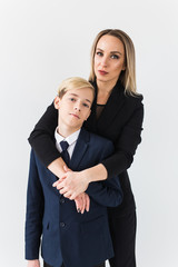 Teenager and single parent - Young mother and son standing together on white background.