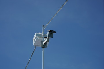 Security camera for on an antenna mouse the blue sky